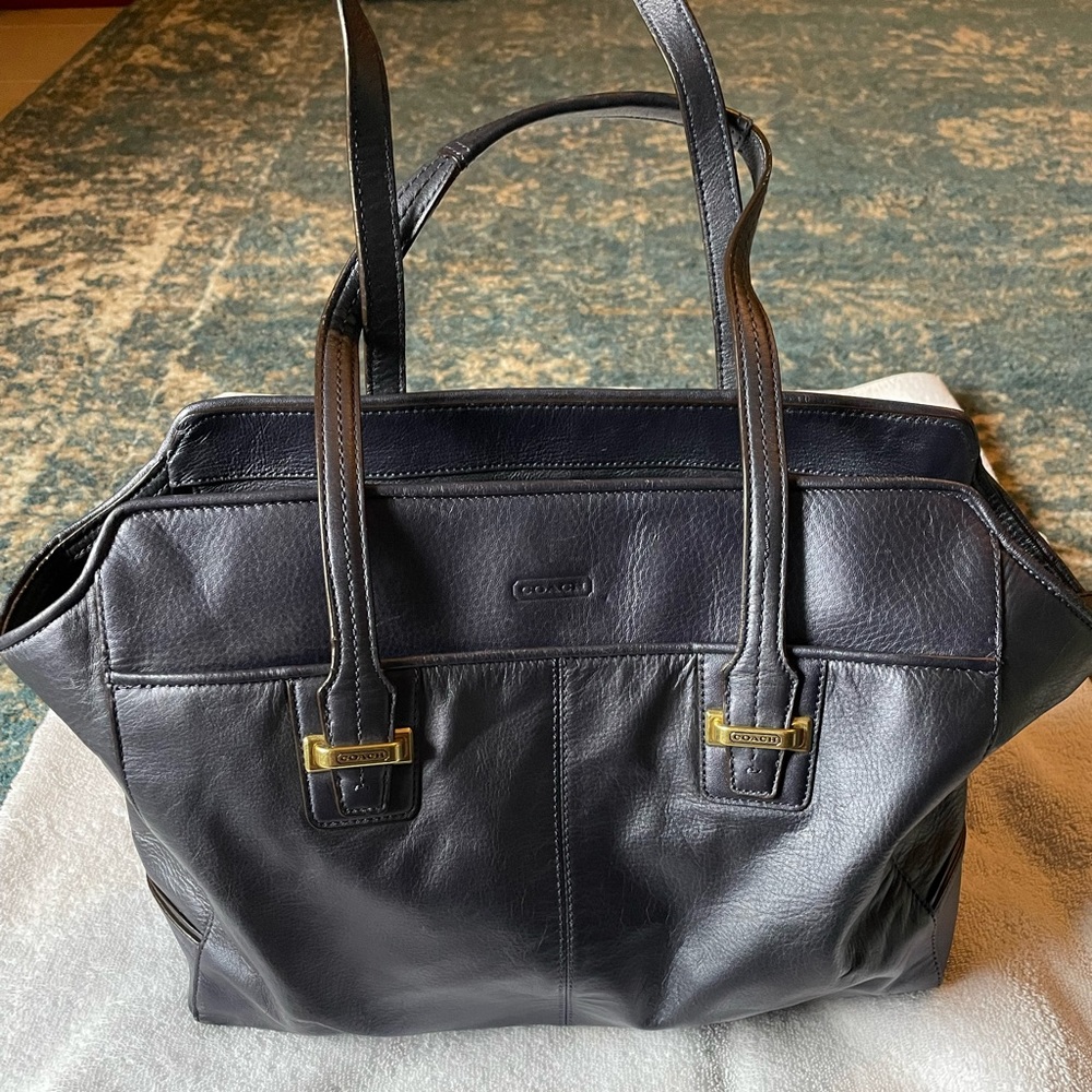 Navy Blue Woman’s Coach handbag.